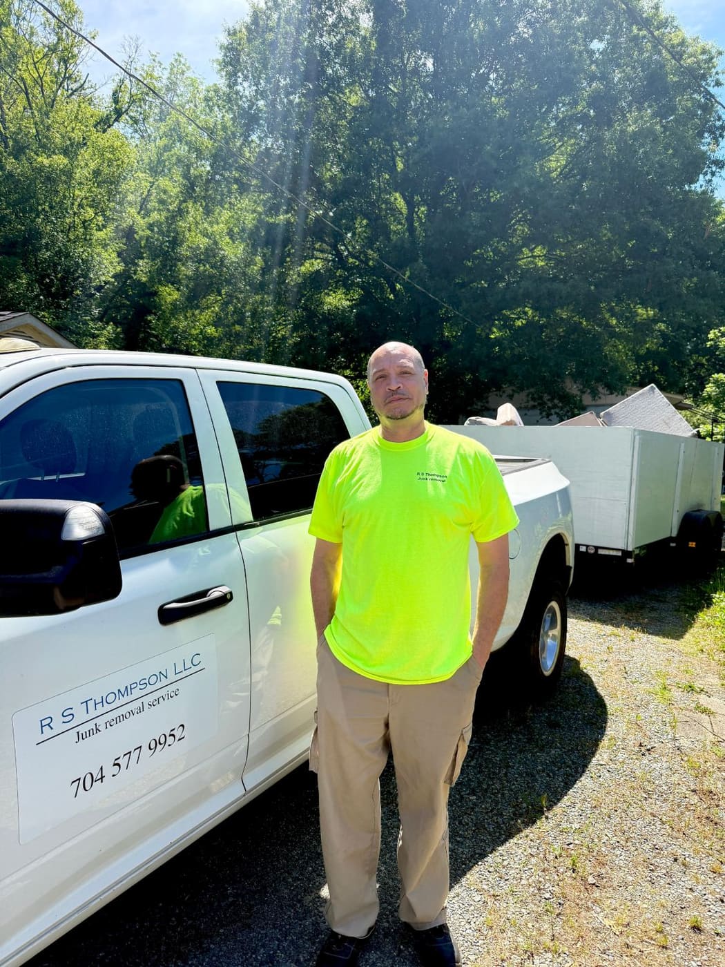 Reginald Thompson, veteran and owner of R. S. Thompson, LLC, standing beside his company truck and trailer